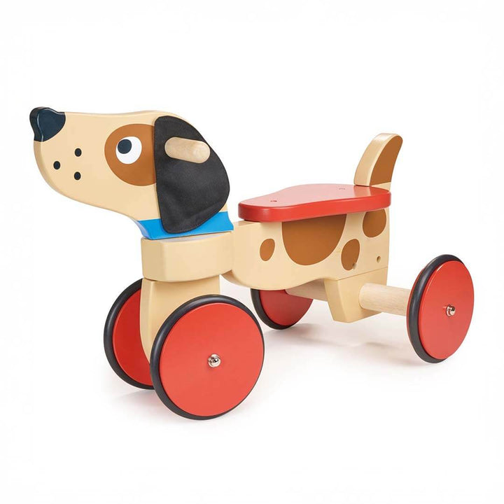 Wooden toy dog with red wheels on a white background