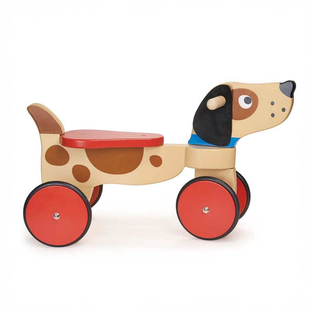 Wooden toy dog with red wheels on a white background
