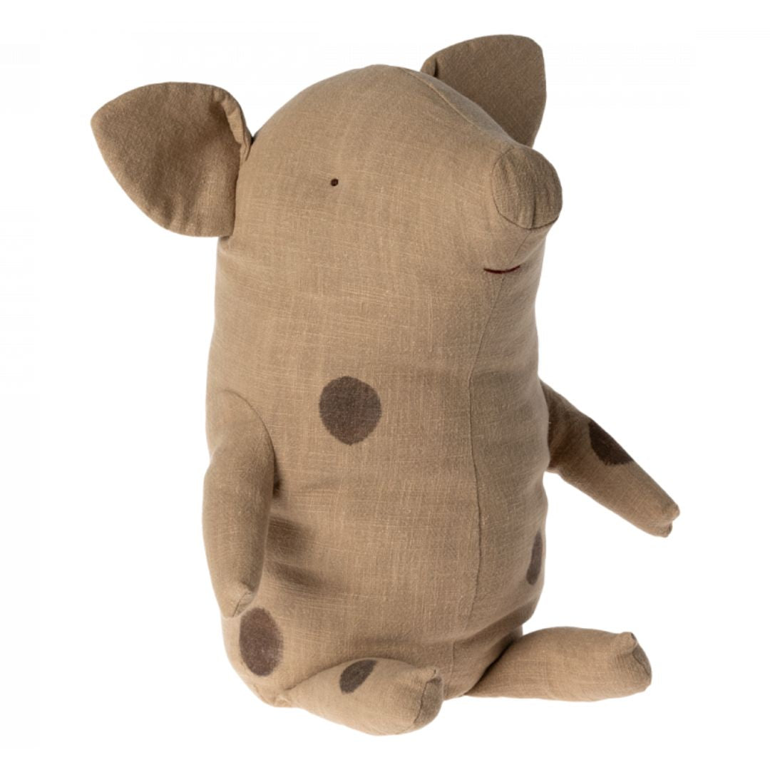 A light brown Maileg pig stuffed animal with dark brown spots.