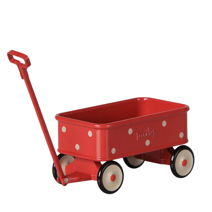 A red metal toy wagon with white polka dots, cream-colored wheels, and a red handle, shown on a plain white background.