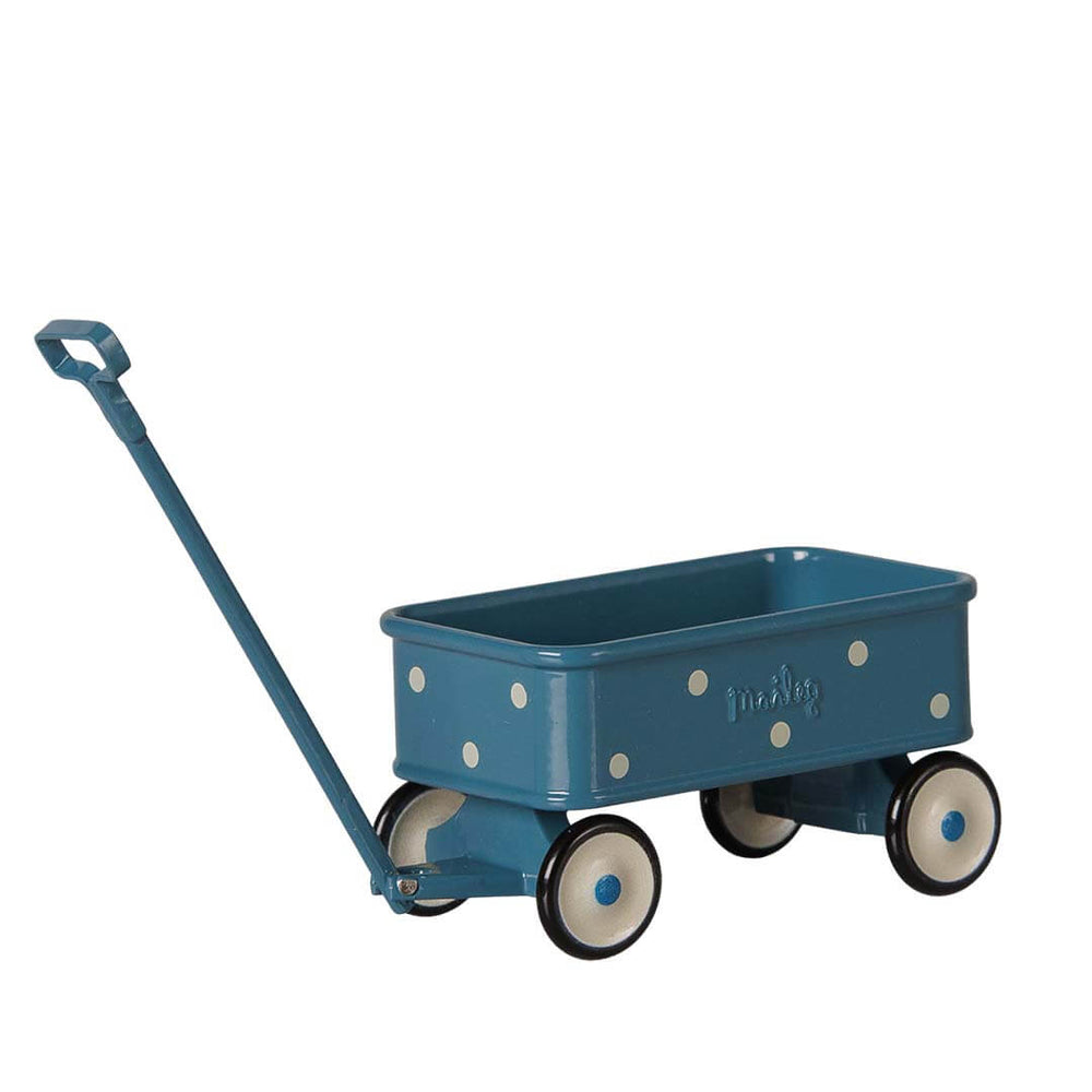 A blue toy wagon with white polka dots, cream-colored wheels with black trim, and a matching blue handle, shown on a plain white background.