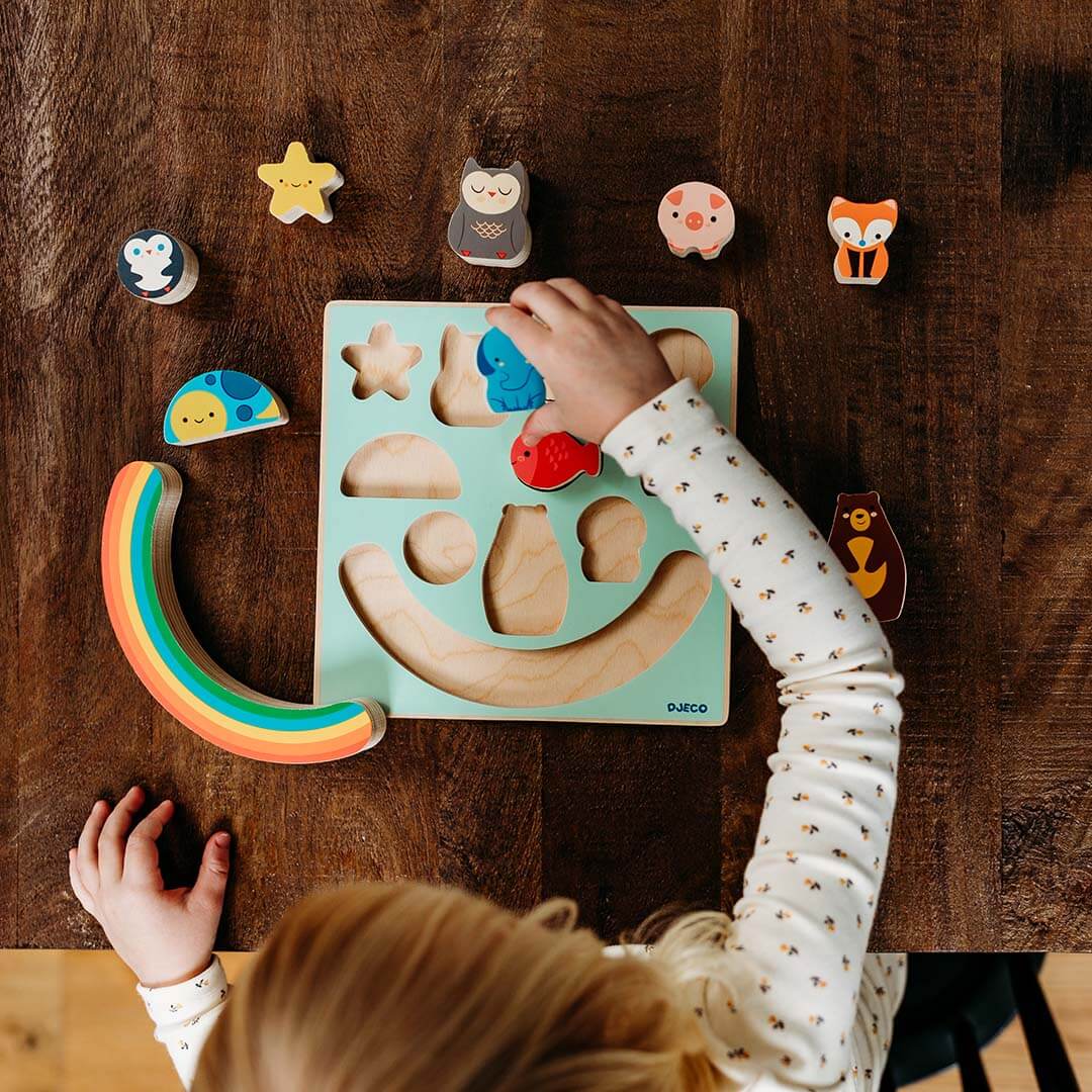 Puzz & Boom Animal Rainbow Wooden Puzzle on a wooden table in use.