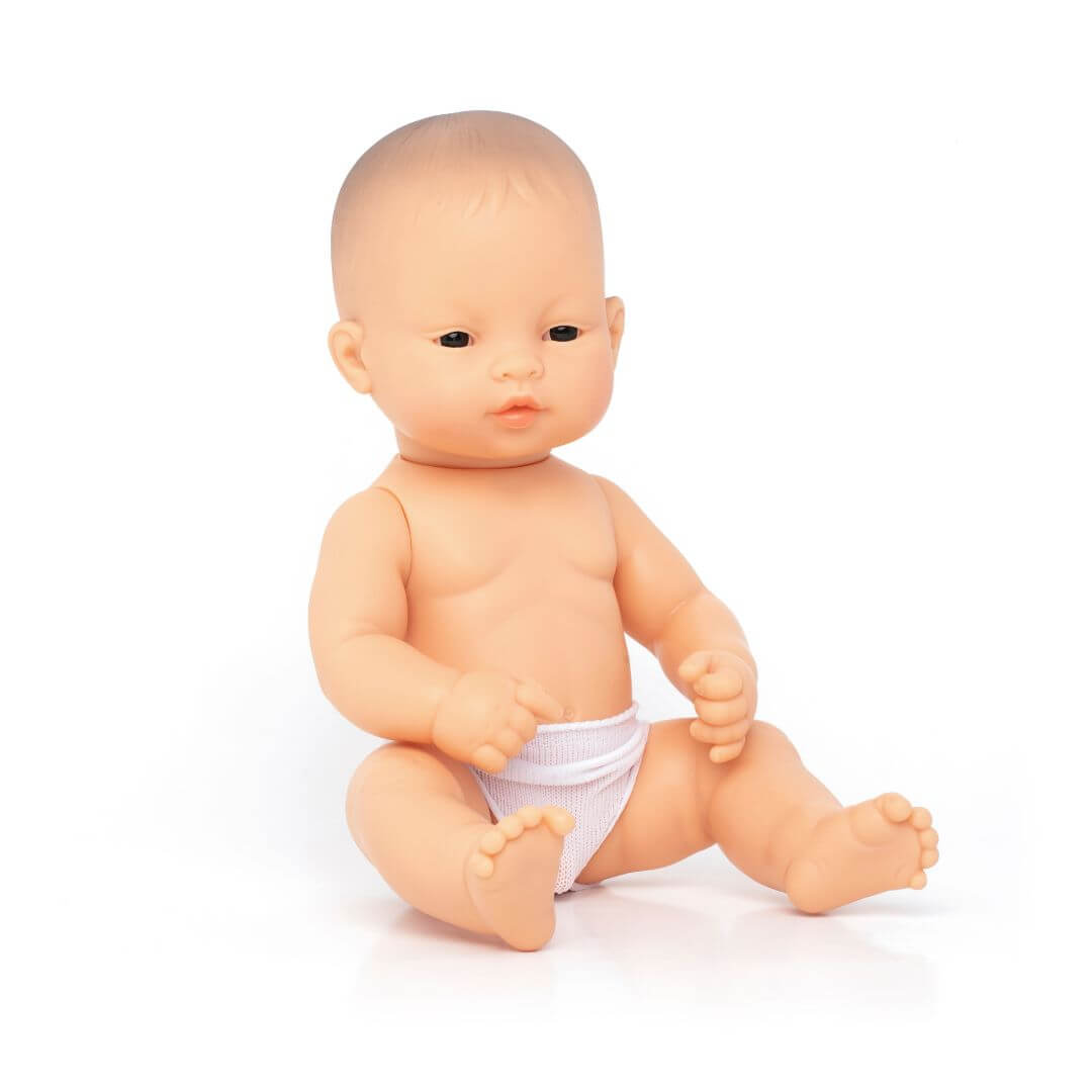 A Miniland 12-inch Realistic Montessori  Asian Boy Baby Doll. Anatomically correct and designed for inclusive, educational play.