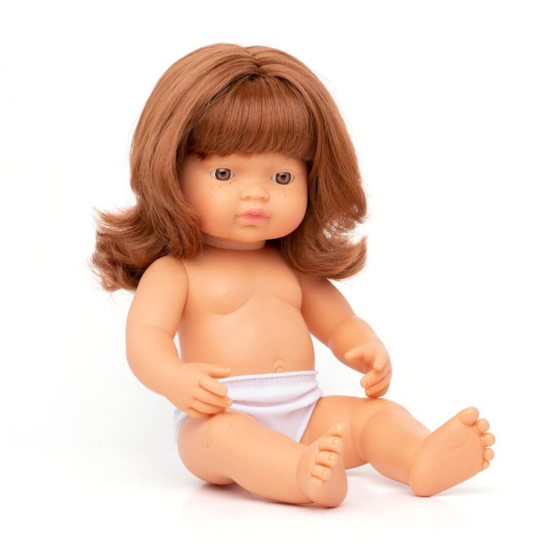A 12-inch Miniland Realistic Montessori Baby Doll – Red-haired Girl, featuring anatomically correct details, and soft vinyl construction. Designed for inclusive, educational play.