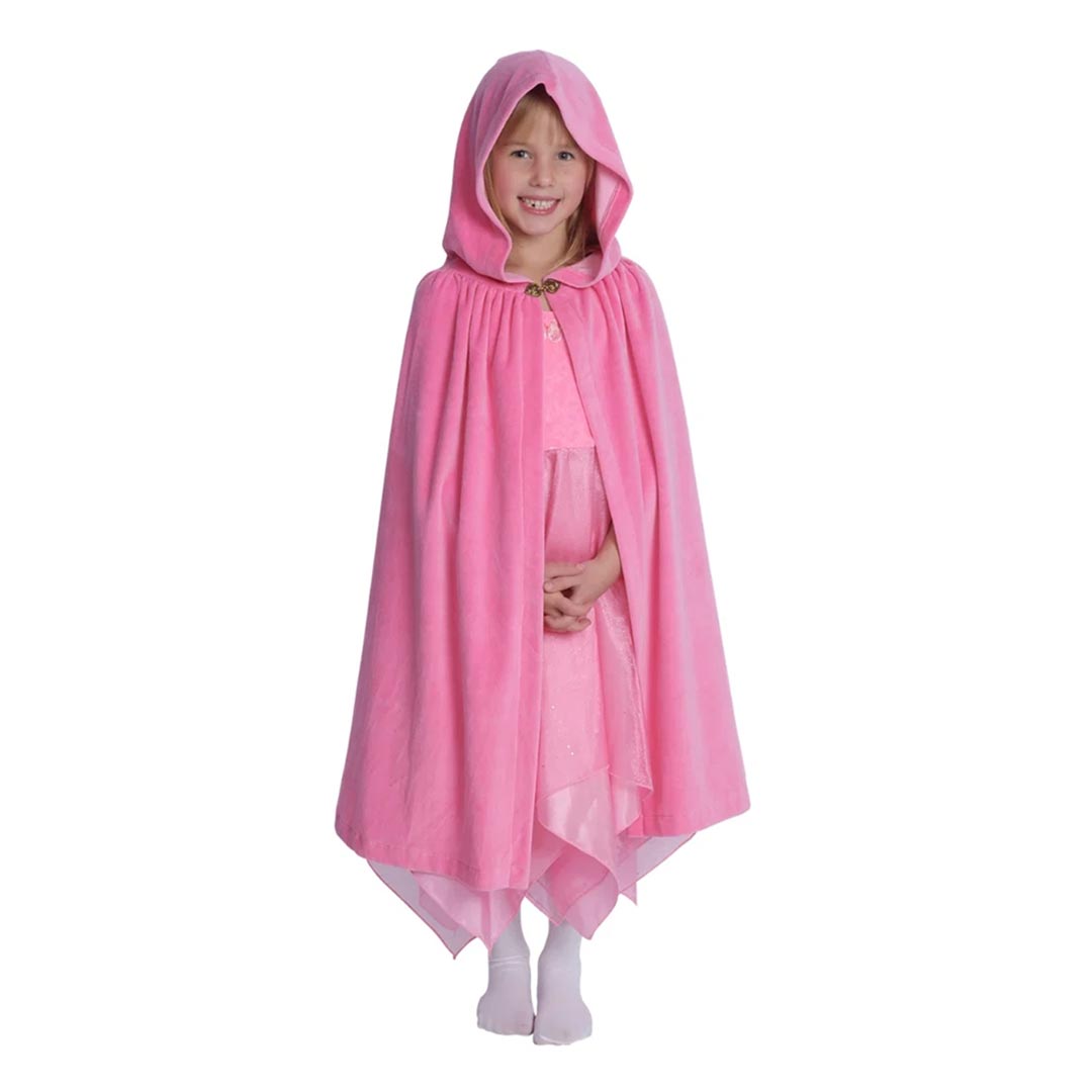 A young girl wearing a pink hooded cape over a matching pink dress, standing against a plain white background.