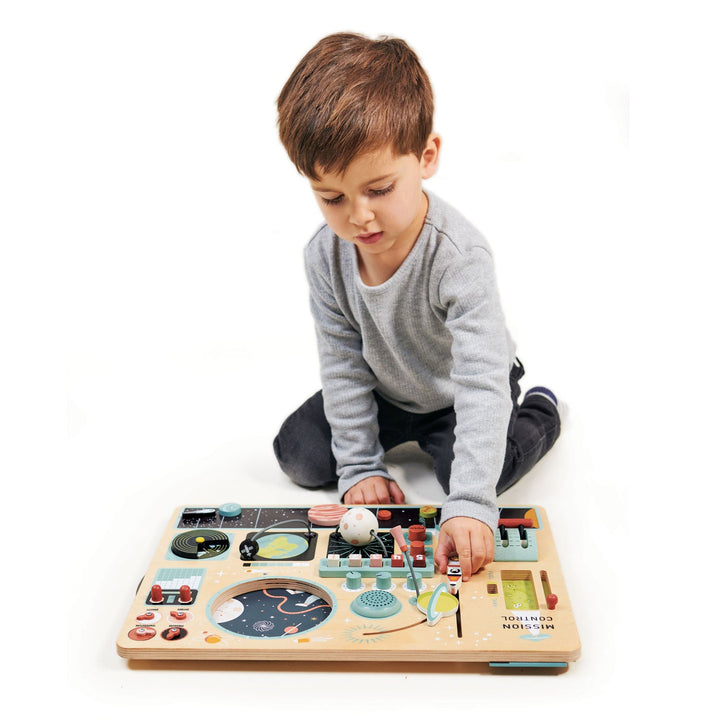 Boy playing with Tender Leaf Toys - Wooden Space Station
