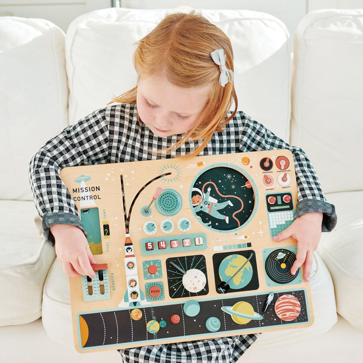 Girl holding Tender Leaf Toys - Wooden Space Station