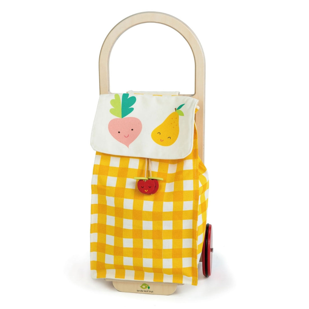 Tender Leaf Toys Pull Along Shopping Trolley with yellow checkered pattern and fruit decorations.