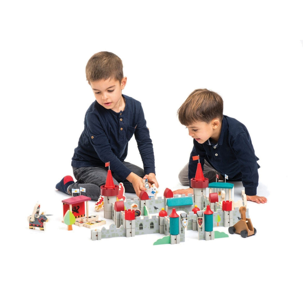 Two children play with the Tender Leaf Toys Wooden Royal Castle Play Set.