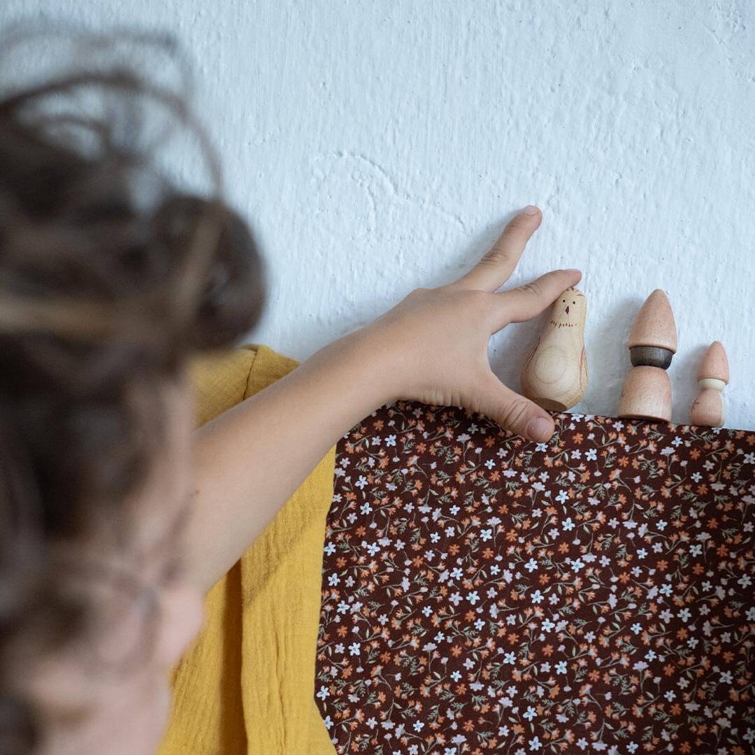 Child playing with Grapat Moonlight wooden figures