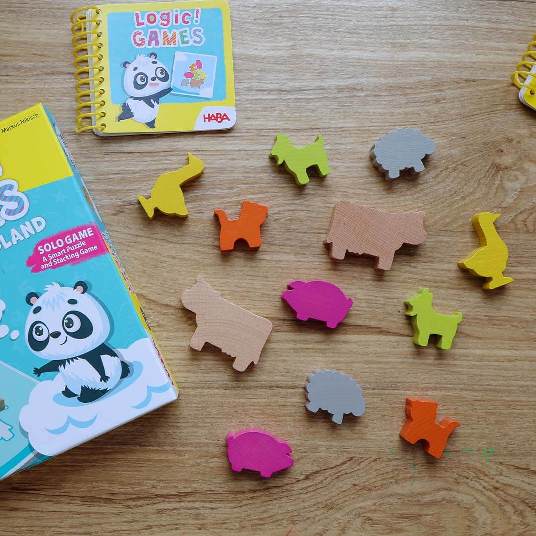 Colorful animal-shaped wooden game pieces on a wooden surface.