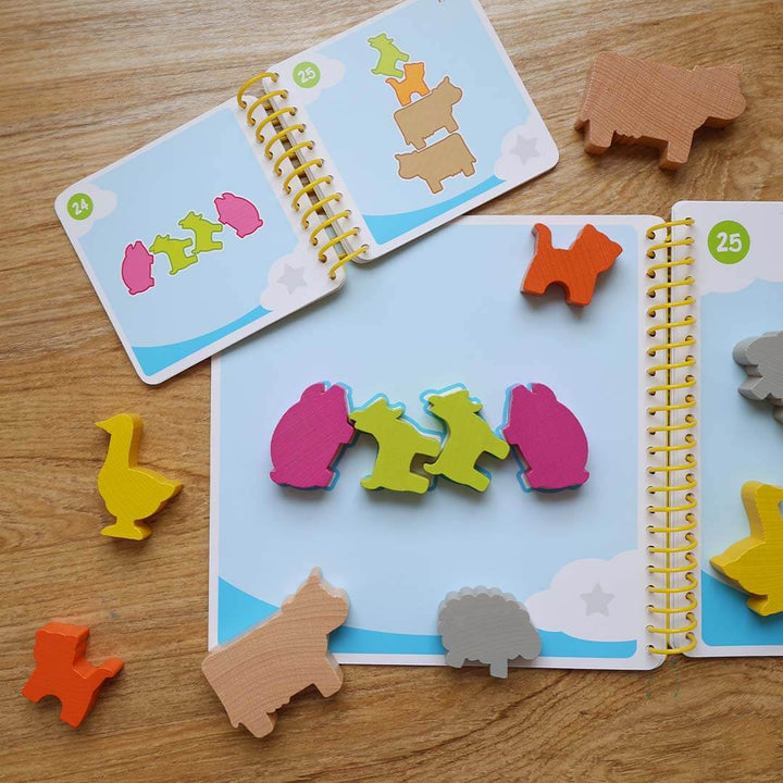 Children's puzzle game with animal shapes on a wooden surface.