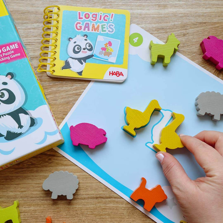 Children's educational game with animal-shaped pieces on a wooden surface.