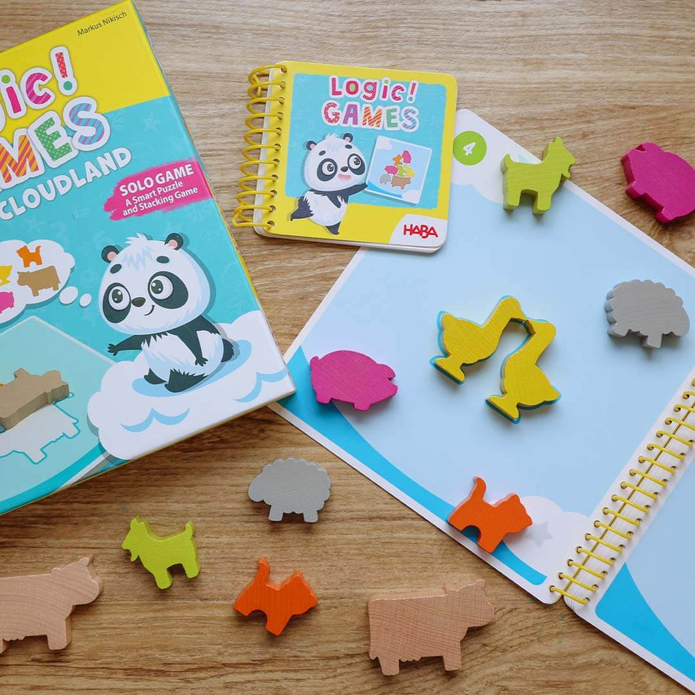 Children's educational games with animal-themed puzzle pieces on a wooden surface.