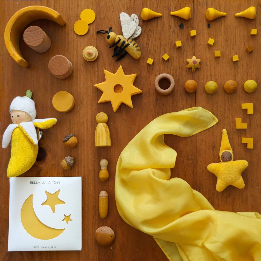 Bella Luna Toys Yellow Play Silk with a collection of other yellow items.