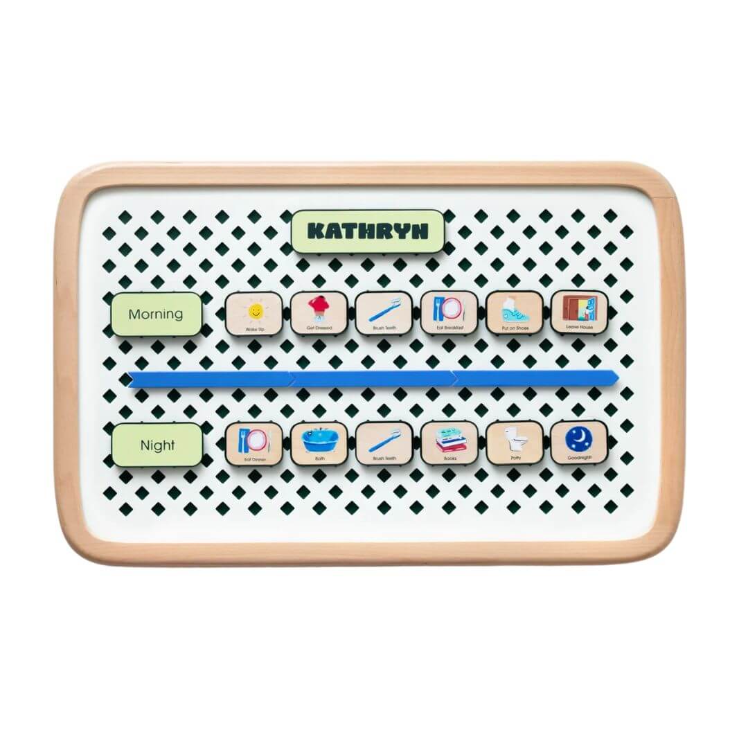 Small Charmspring visual routine board displaying morning and night picture tiles arranged on a patterned backing, shown on a white background. Bella Luna Toys