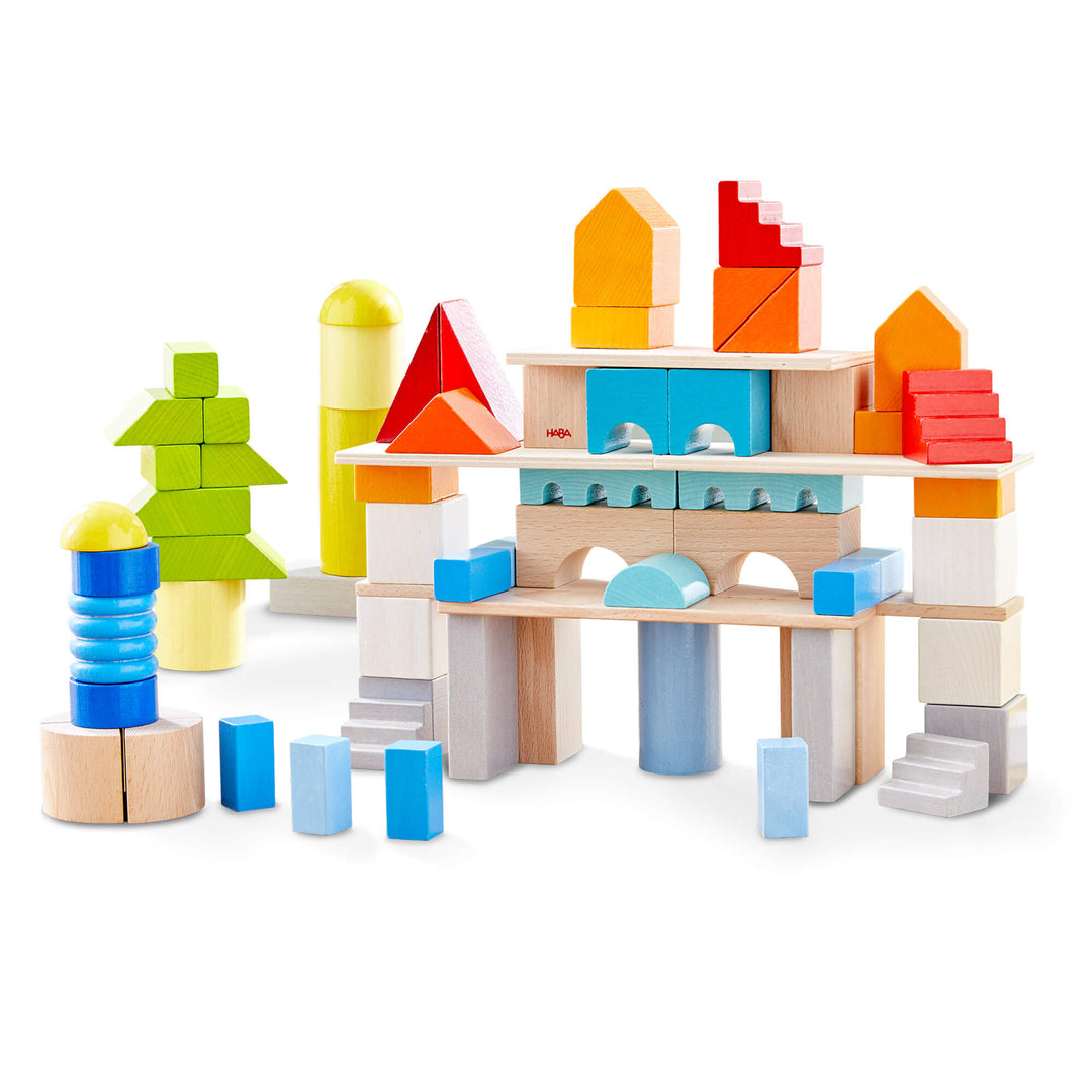 HABA Colored Building Blocks 85 Piece Set with green, blues, red, orange, yellows, white, gray, and natural colored wooden building blocks.