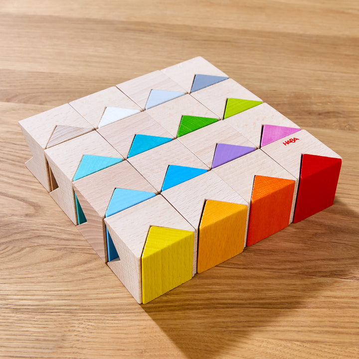 Colorful Triangle Wooden Block Game's colorful wooden puzzle blocks arranged on a wooden surface.