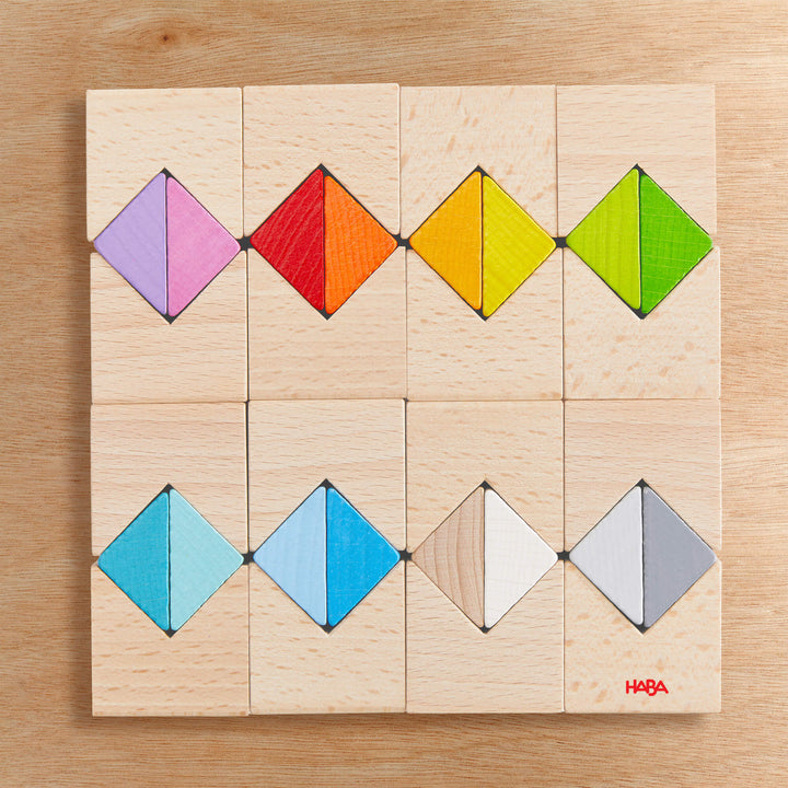 Wooden blocks with colorful triangle pieces on a wooden surface.