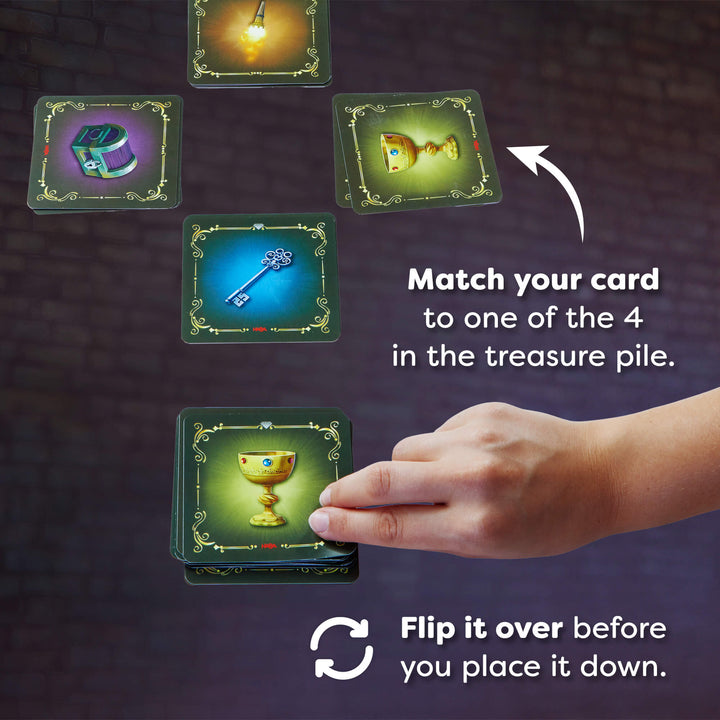 Card game instruction with cards and a hand on a dark background