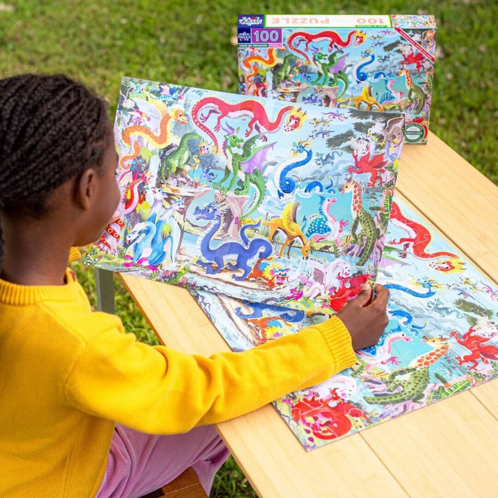Child playing with a colorful puzzle on a wooden table outdoors