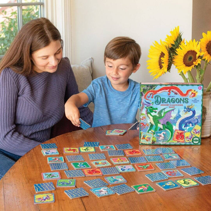 A child and parent playing Shiny Dragons Memory & Matching Games.