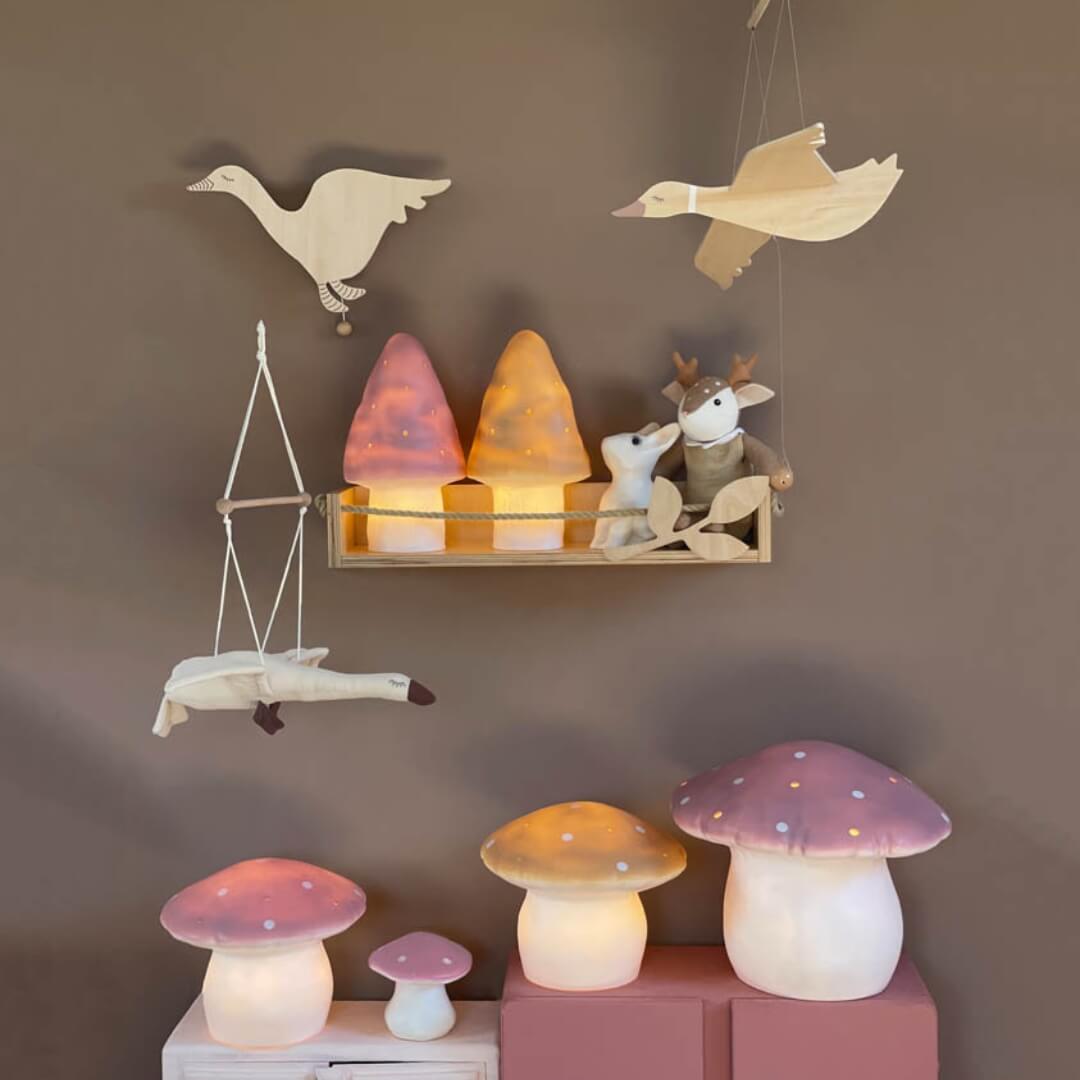 Decorative wall shelf with animal-themed lamps and a collection of mushroom-shaped lamps featuring the flying goose mobile.