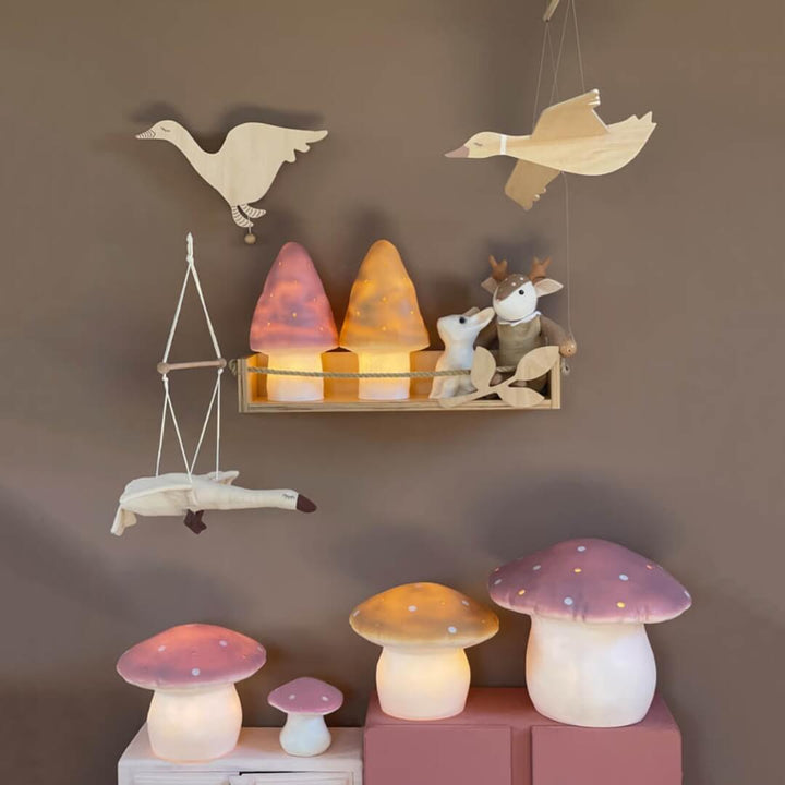 Decorative wall shelf with animal-themed lamps and a collection of mushroom-shaped lamps featuring the flying goose mobile.