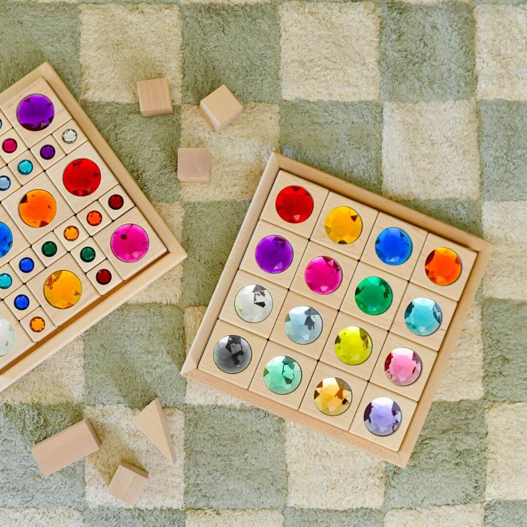 Colorful wooden puzzle with geometric shapes on a checkered floor