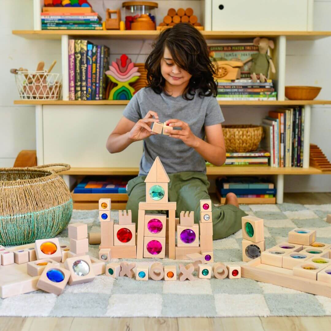 Child playing with wooden blocks in a room with shelves and books.
