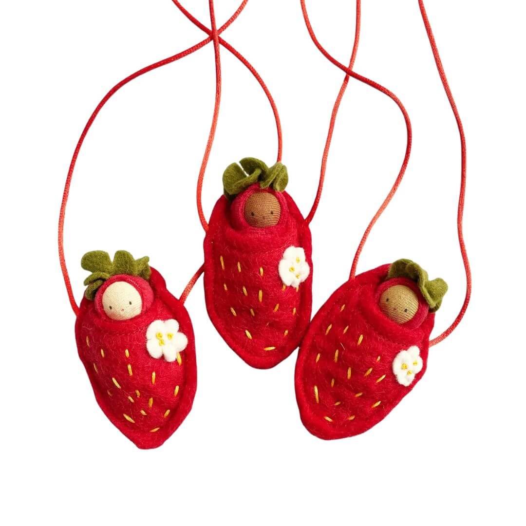 Felt strawberry baby necklaces on a white background.
