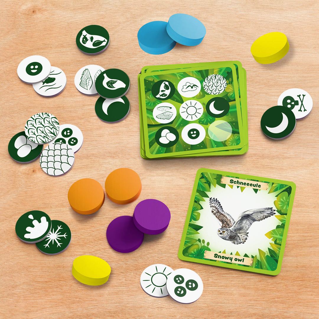Board game components including cards and tokens on a wooden surface