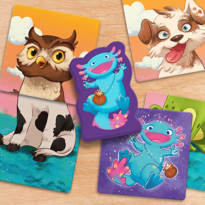 Cards with colorful illustrations including an owl head, a dog head, a cow body, and a joyful blue axolotl  with a pink tail and sparkles.