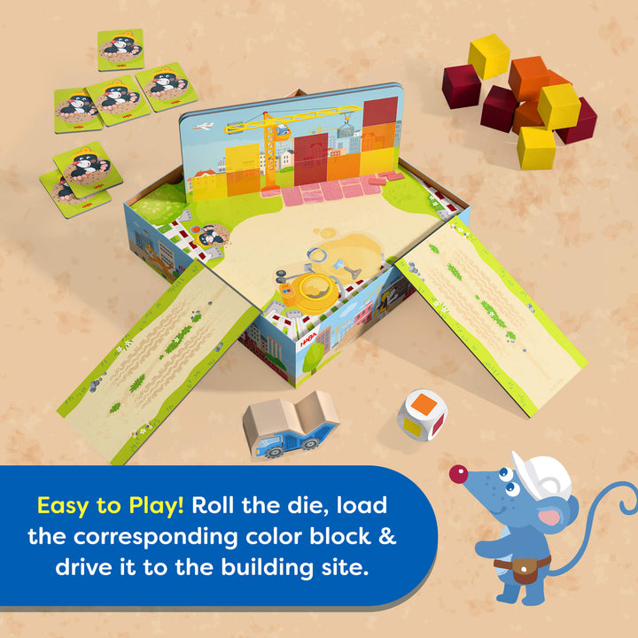 Children's My Very First Games - Block by Block building block set with game board and cartoon character on a beige background. Text reads "Easy to Play! Roll the die, load the corresponding color block & drive it to the building site."