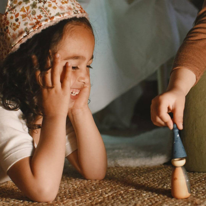Two children exploring treasures from the Grapat 2025 Advent Calendar, one holding a wooden piece while the other leans over a step – Bella Luna Toys.