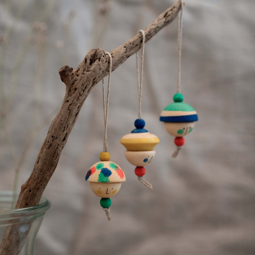 Grapat Holiday Ornaments - Kind Folks - Ornaments hanging from a branch.