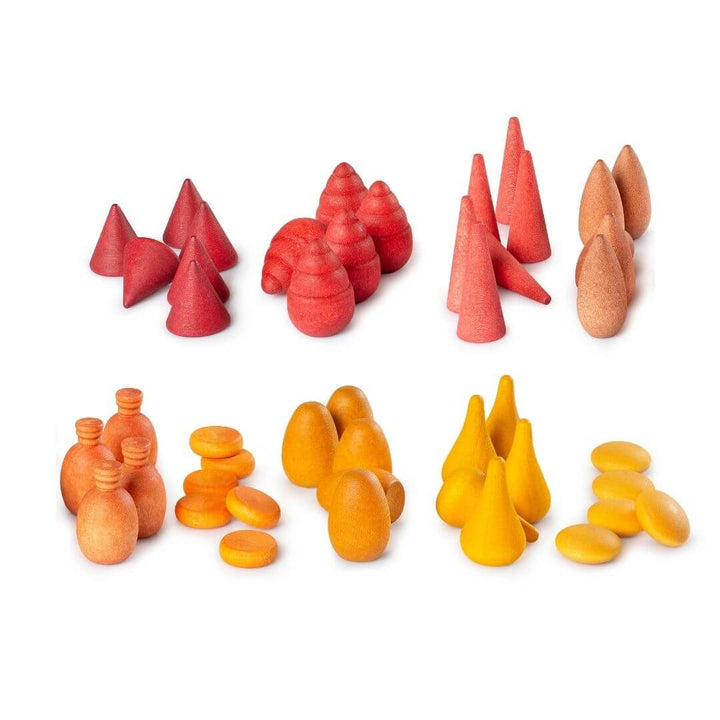 A close up of several of the Grapat Mandala Mix Warm set in red, orange, and yellow tones arranged by shape with a white background - Bella Luna Toys