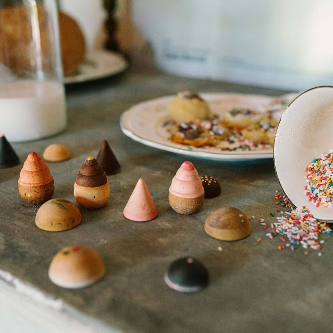 Grapat wooden breads and cookies play set with hand-painted wooden bakery pieces shown in a kitchen with other real baking supplies - Bella Luna Toys