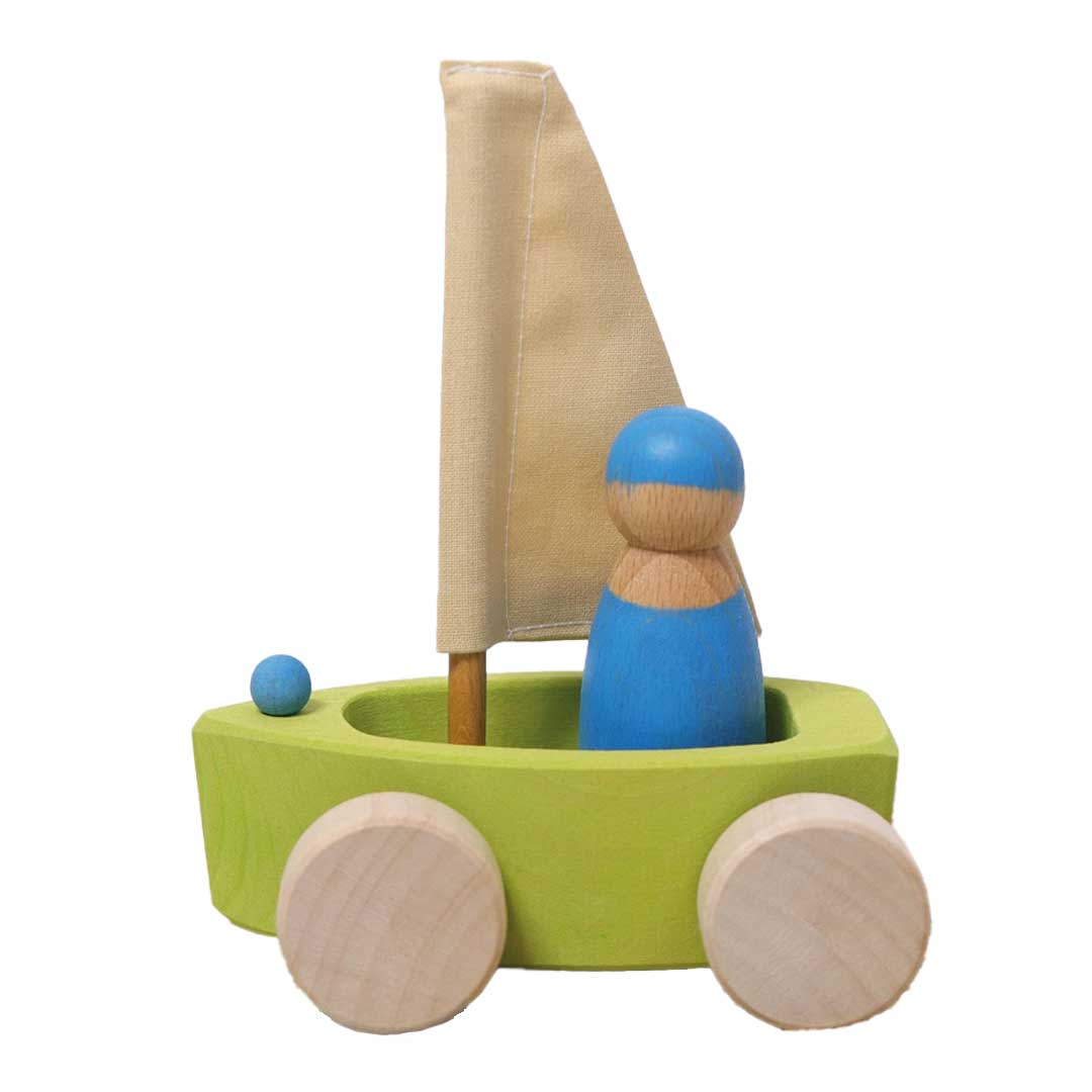 Wooden toy boat with a sail and wheels on a white background