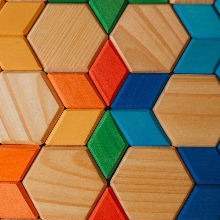 Colorful wooden hexagonal blocks arranged in a pattern.