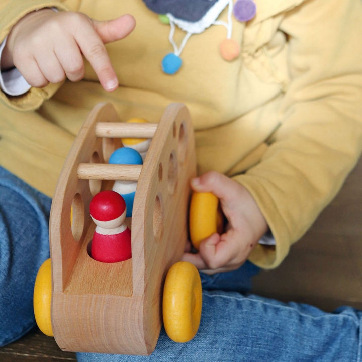 Grimms Bus- Wooden Toy Vehicles- Child playing with wooden toy vehicle with wooden nins- Bella Luna Toys
