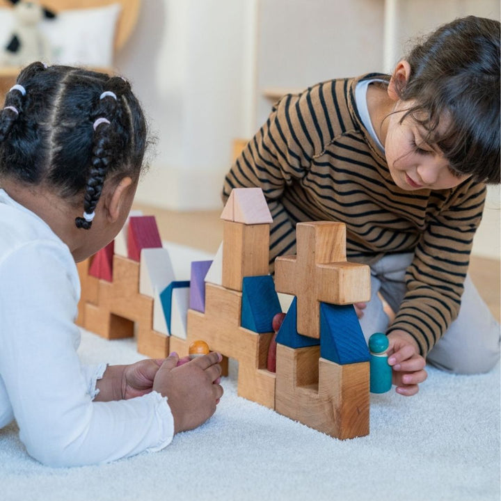 Children building with blocks from the Grimm's Wooden Toys Tiny Art Collection