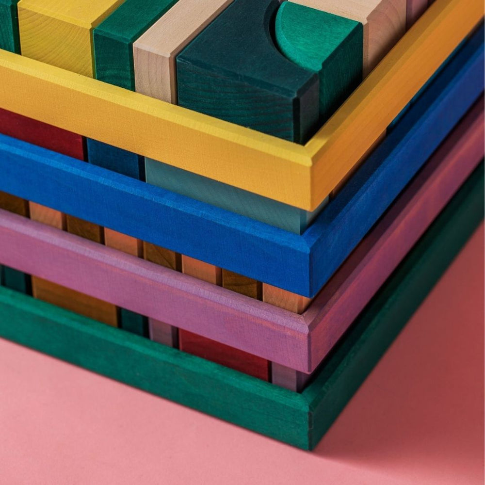 4 colorful Grimm's wooden block trays from the Tiny Art collection.