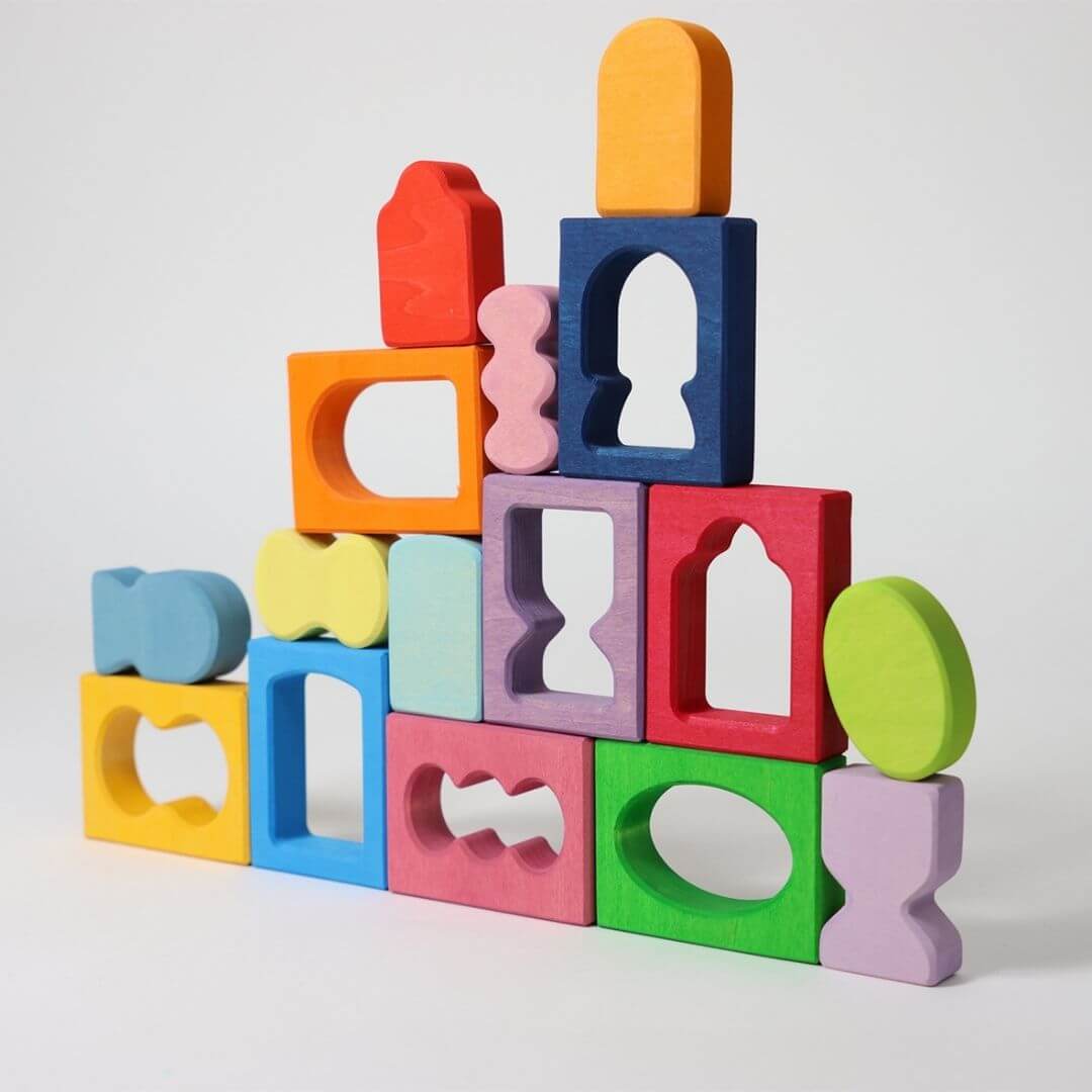 Grimm’s Windows Wooden Building Set arranged in a tall, colorful tower of interlocking shapes, showing creative building and color harmony in play. Bella Luna Toys
