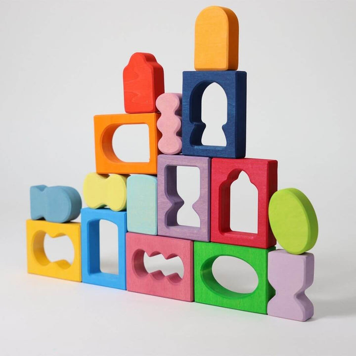 Grimm’s Windows Wooden Building Set arranged in a tall, colorful tower of interlocking shapes, showing creative building and color harmony in play. Bella Luna Toys