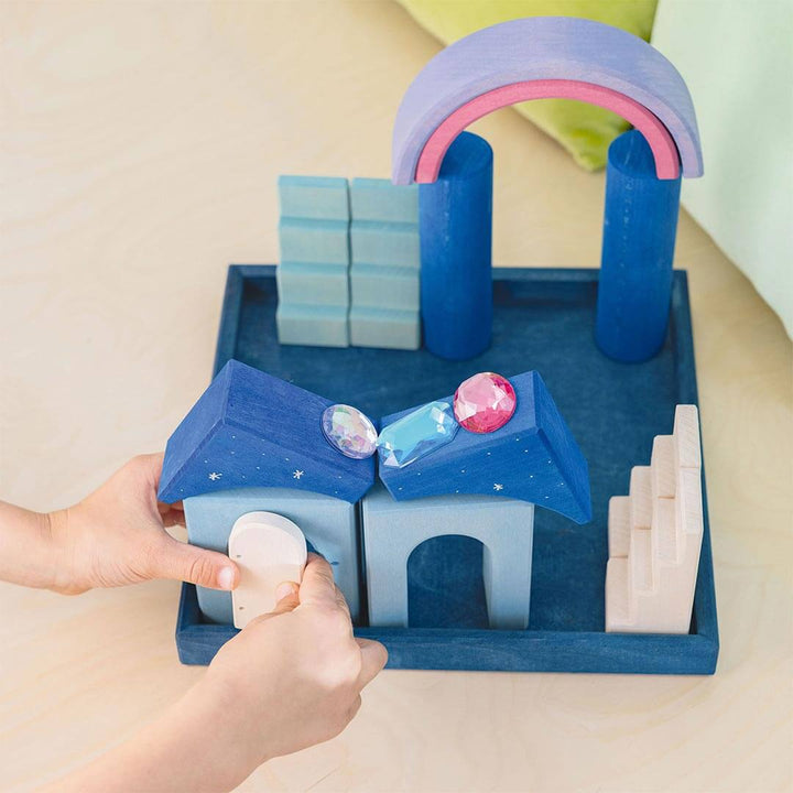 Kid playing with Grimm's Wooden Building World Polar Light Set