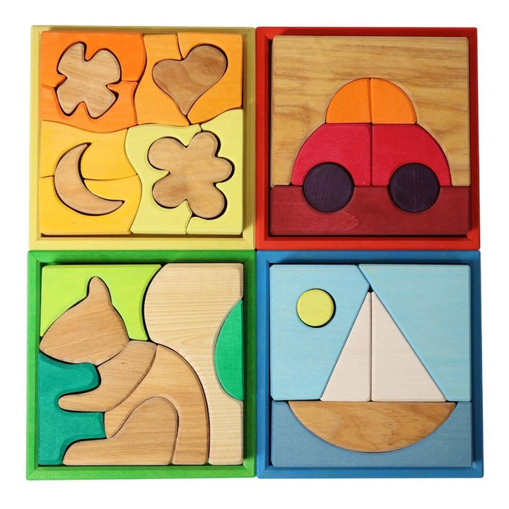 Four Grimm’s Wooden Puzzle and Building Sets in a wooden tray, featuring colorful nature- and vehicle-inspired scenes in red, yellow, green, and blue for open-ended play. Bella Luna Toys