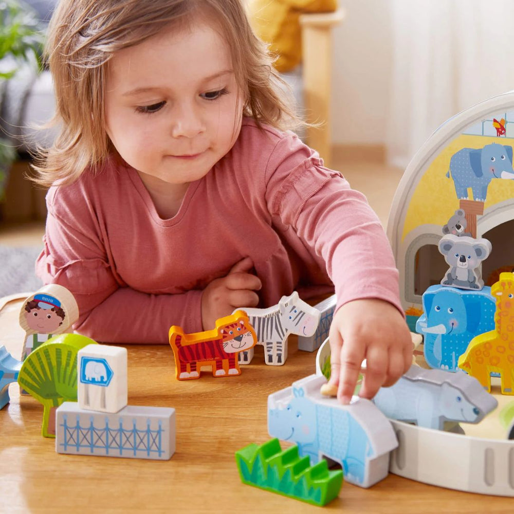 HABA Play World at the Zoo Set- Child playing with Zoo inspired wooden figurines- Bella Luna Toys