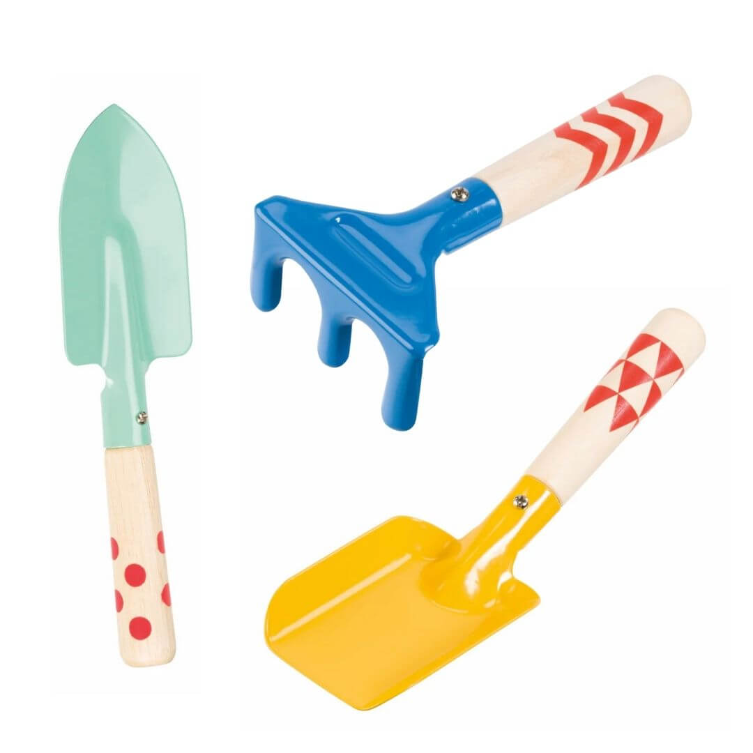Three child-sized garden hand tools including a trowel, rake, and shovel with hardwood handles and colorful metal heads on a white background.