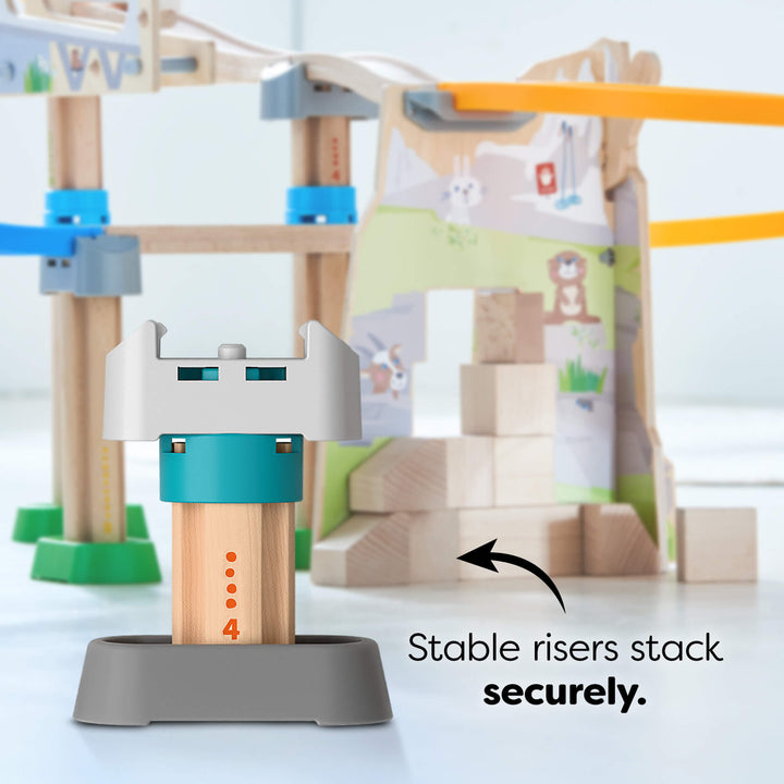 Wooden Kullerbü column with a stable riser, set against a blurred track set background.